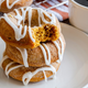 Stack of iced doughnuts on a white plate